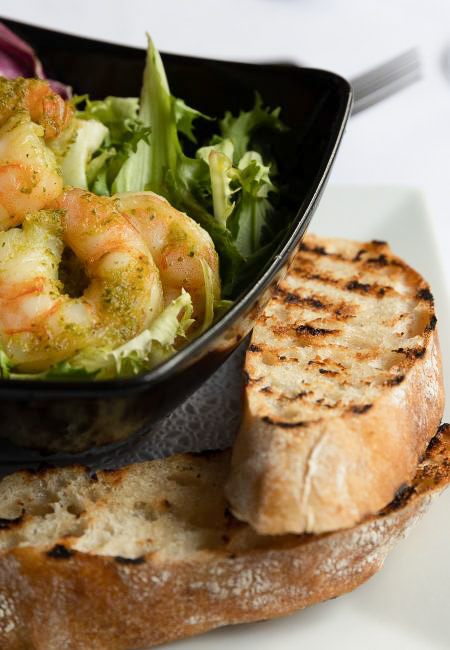 Garlic king prawns on a bed of mixed leaves served with a chargrilled ciabatta